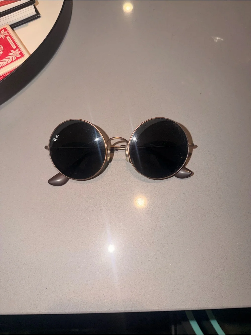 Raybans: Ja-Jo style. Rose gold frame. Black lenses I believe.
